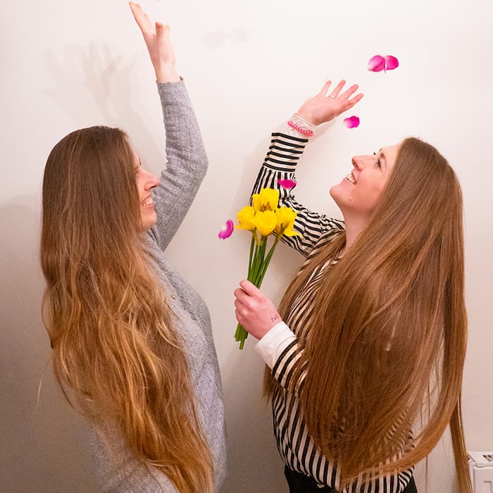 Steph and Jade throwing flowers in the air